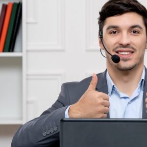 customer-service-handsome-man-grey-suit-with-computer-headset-showing-good-gesture-min-474x841 -